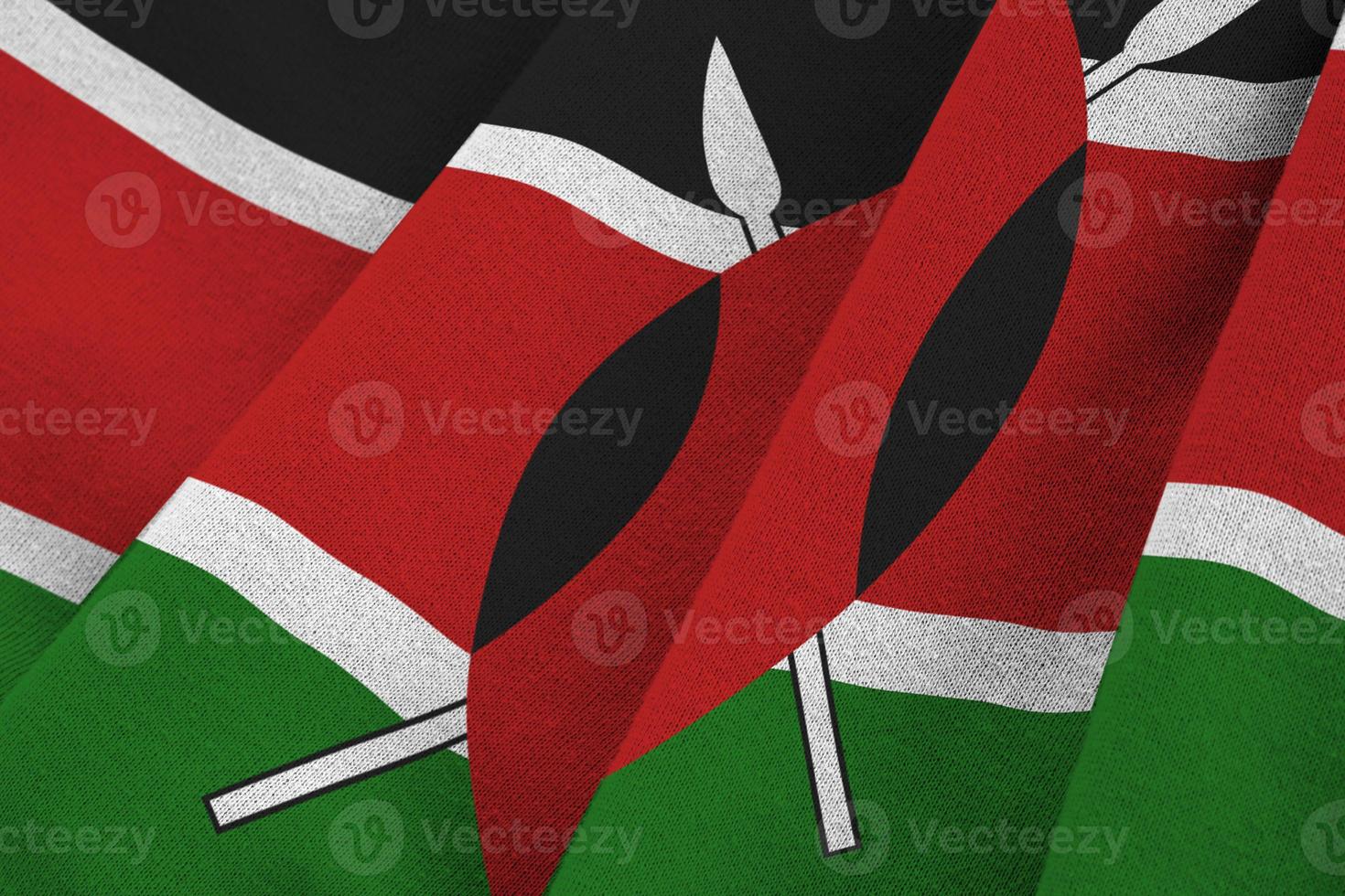 Kenya flag with big folds waving close up under the studio light indoors. The official symbols and colors in banner photo