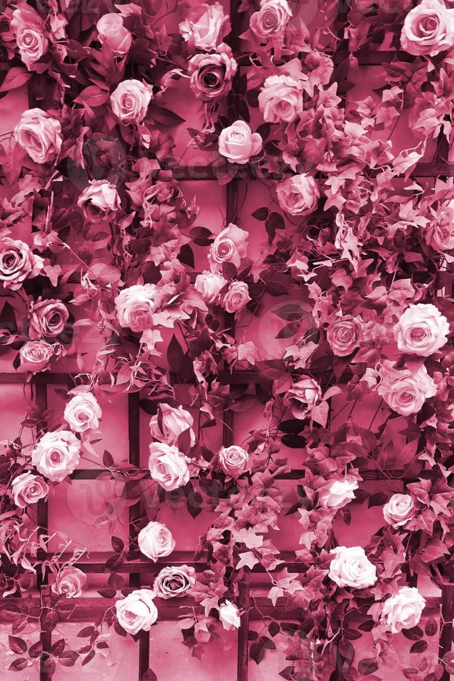 Decoration urban art object from colorful elegant flowers on wall Image toned in Viva Magenta, color of the 2023 year photo