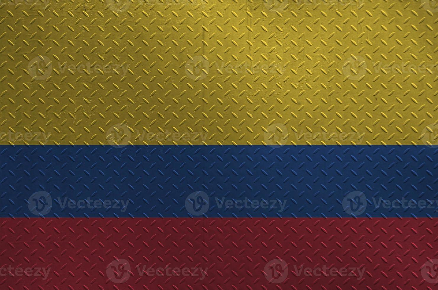 Colombia flag depicted in paint colors on old brushed metal plate or wall closeup. Textured banner on rough background photo