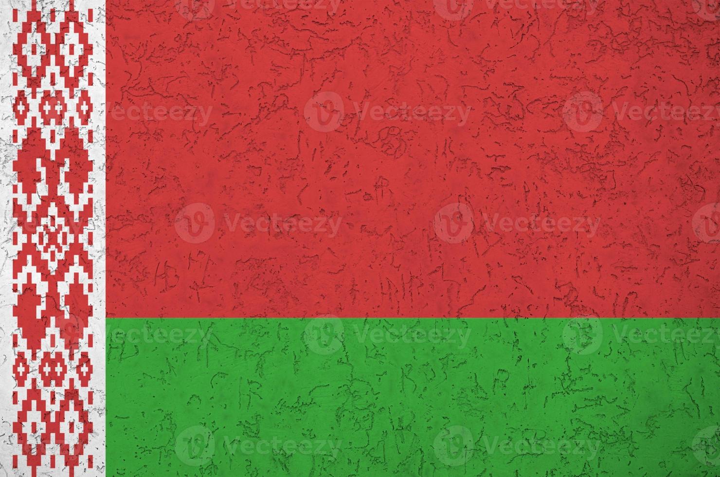 Belarus flag depicted in bright paint colors on old relief plastering wall. Textured banner on rough background photo