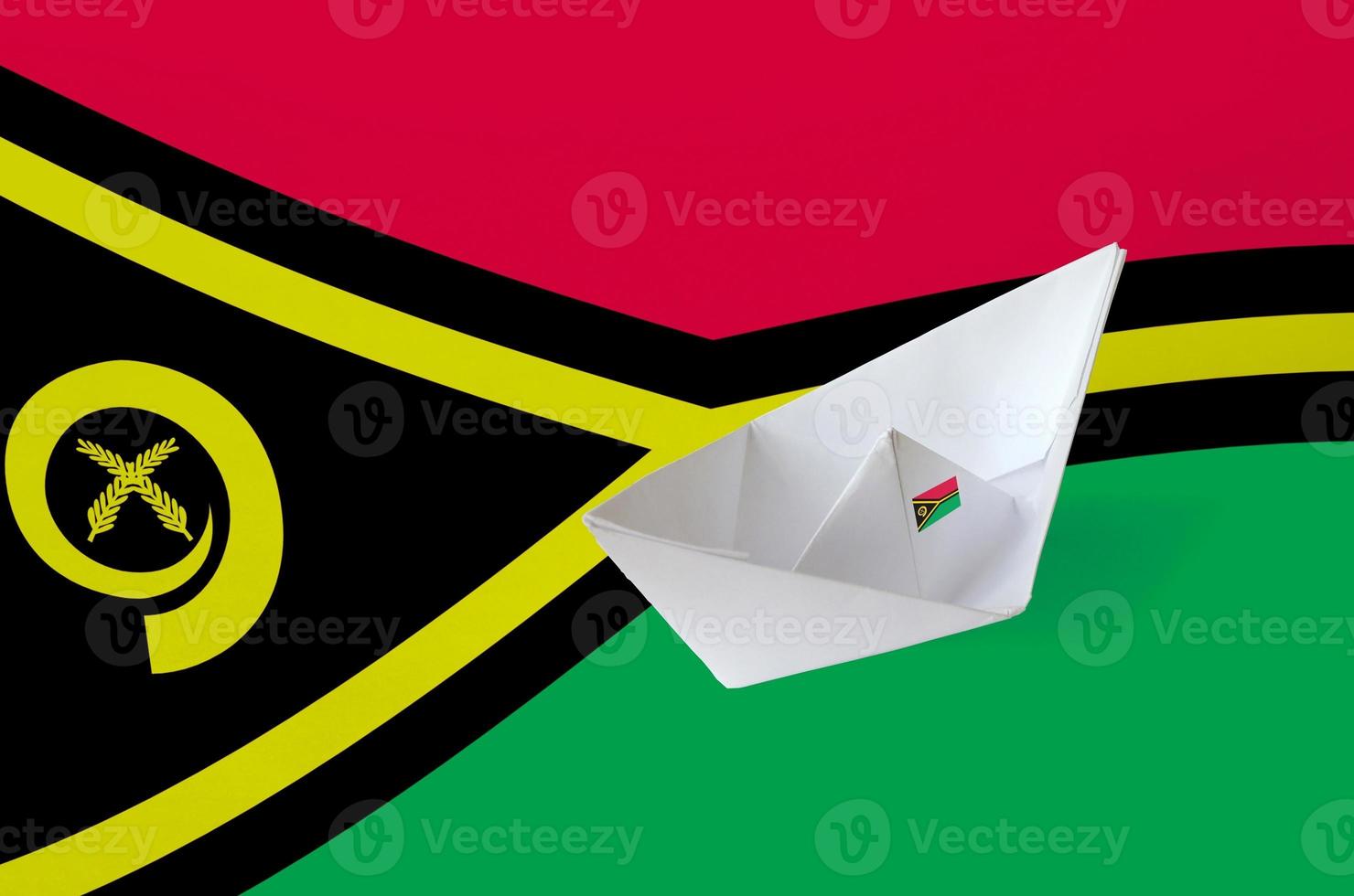 Vanuatu flag depicted on paper origami ship closeup. Handmade arts concept photo