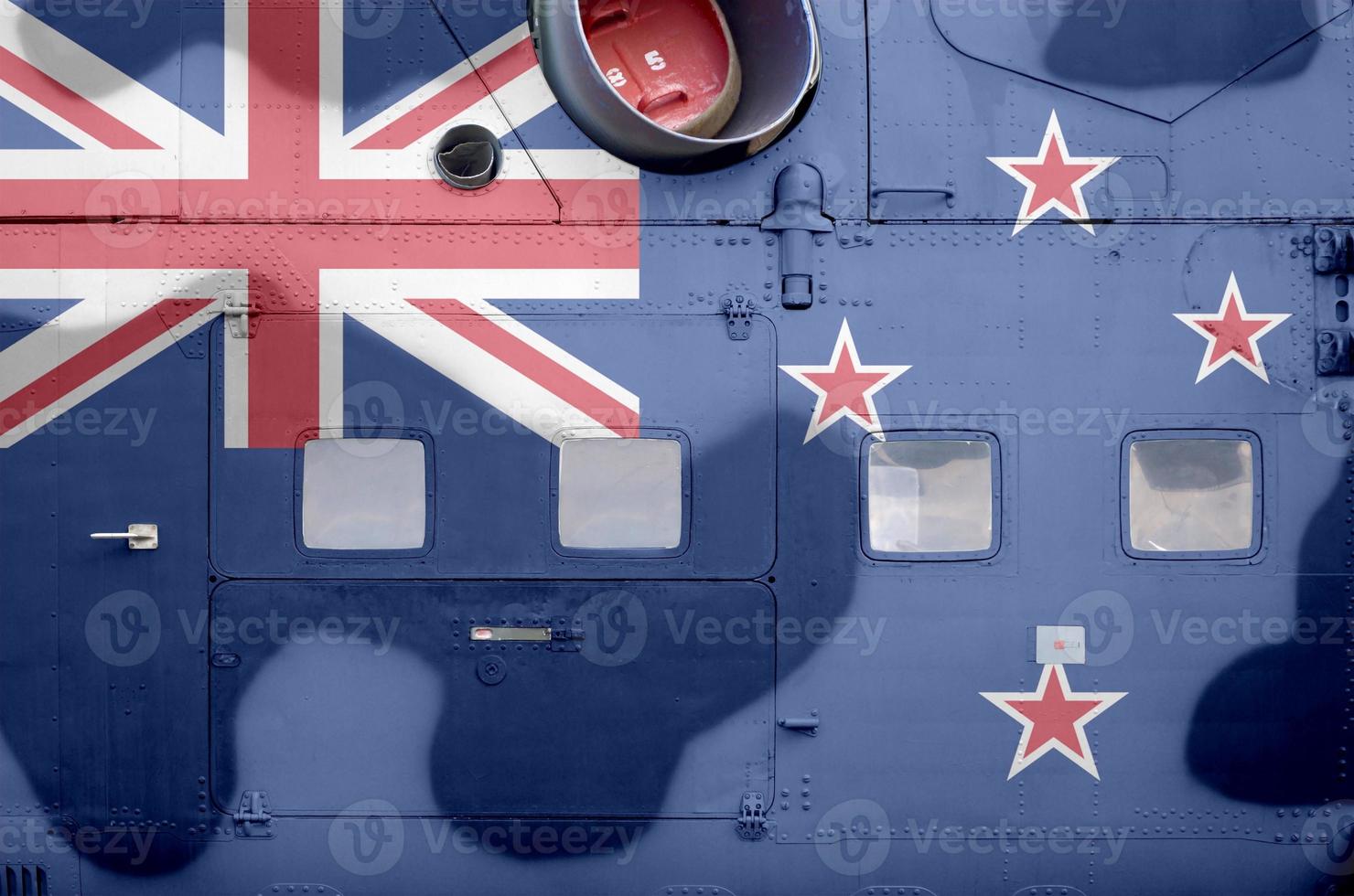 New Zealand flag depicted on side part of military armored helicopter closeup. Army forces aircraft conceptual background photo