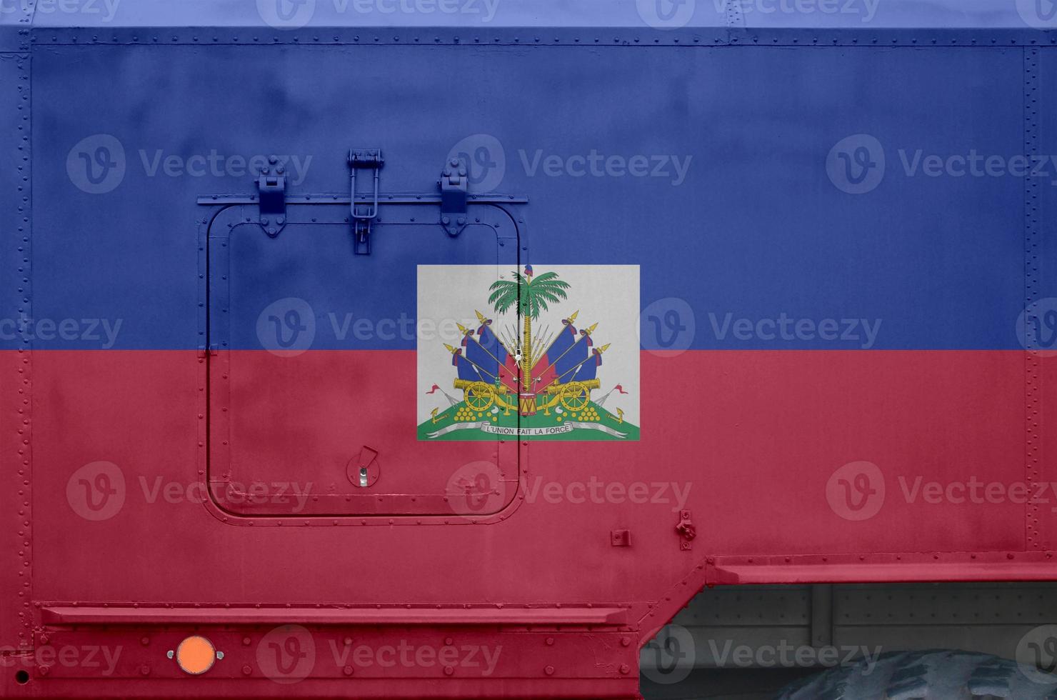 Haiti flag depicted on side part of military armored truck closeup. Army forces conceptual background photo