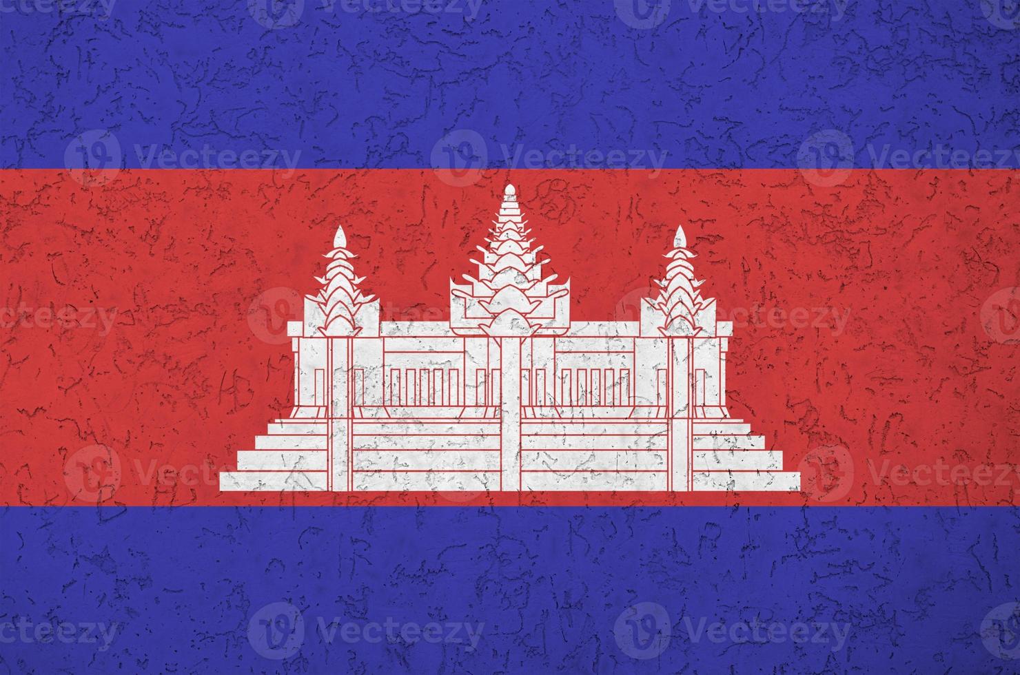 Cambodia flag depicted in bright paint colors on old relief plastering wall. Textured banner on rough background photo