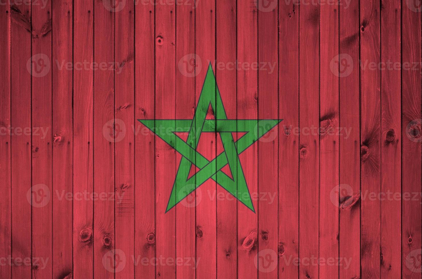 Morocco flag depicted in bright paint colors on old wooden wall. Textured banner on rough background photo
