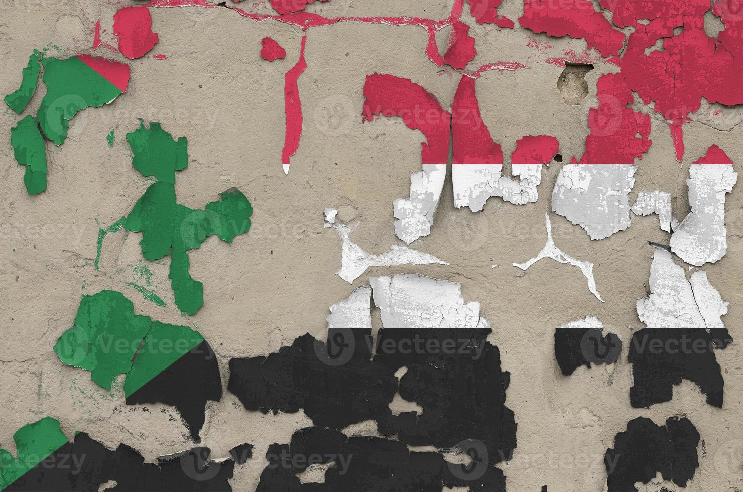 Sudan flag depicted in paint colors on old obsolete messy concrete wall closeup. Textured banner on rough background photo