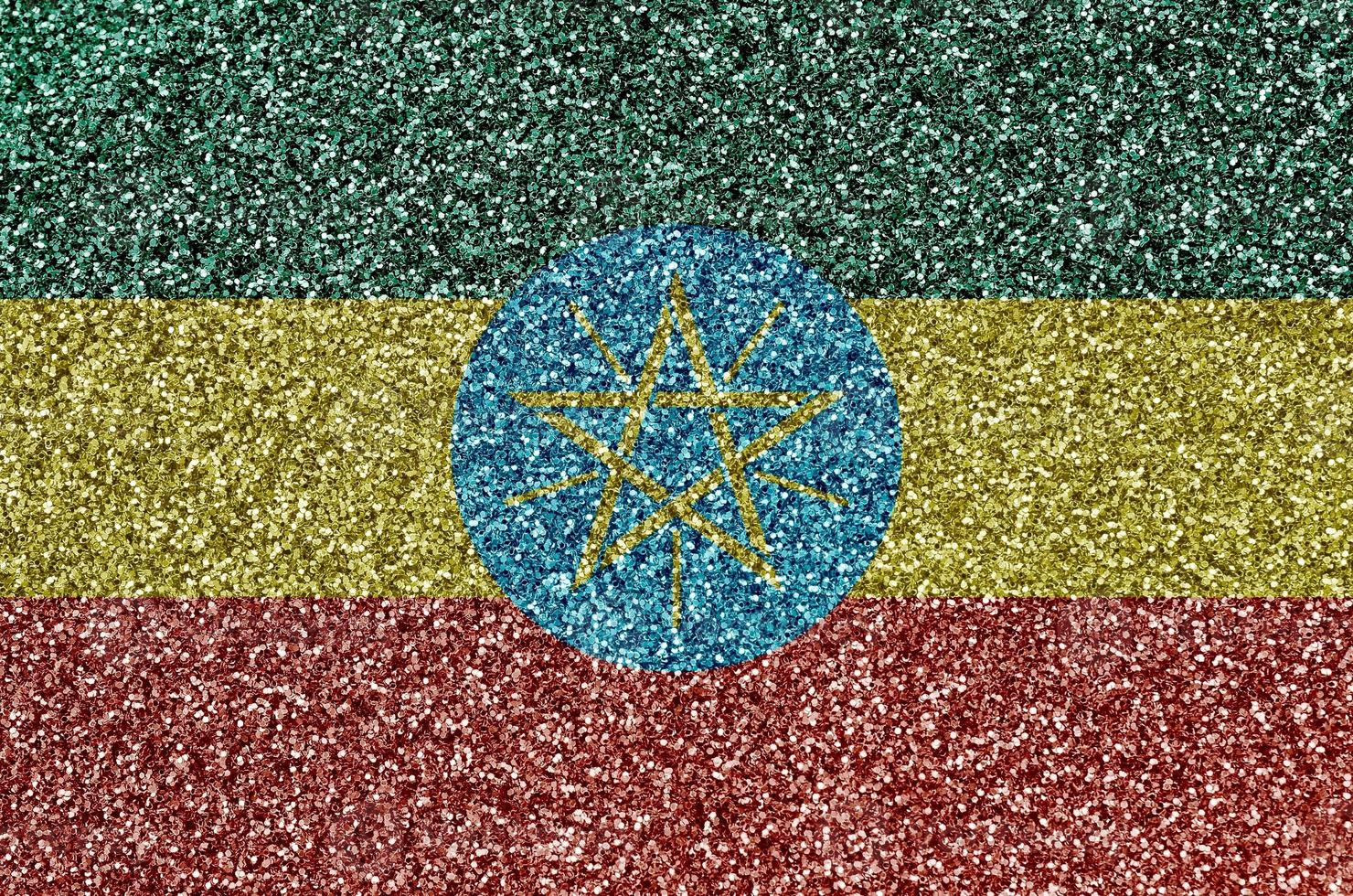 Ethiopia flag depicted on many small shiny sequins. Colorful festival background for party photo