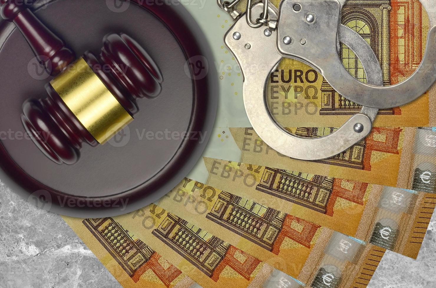 50 euro bills and judge hammer with police handcuffs on court desk. Concept of judicial trial or bribery. Tax avoidance photo