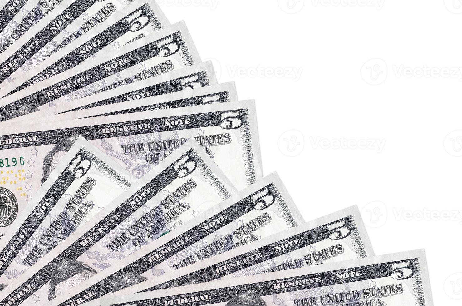 5 US dollars bills lies isolated on white background with copy space stacked in fan close up photo