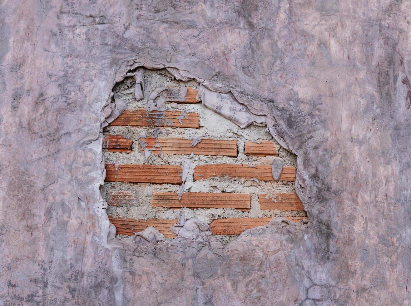 Loft style cement wall with crack and orange brick photo