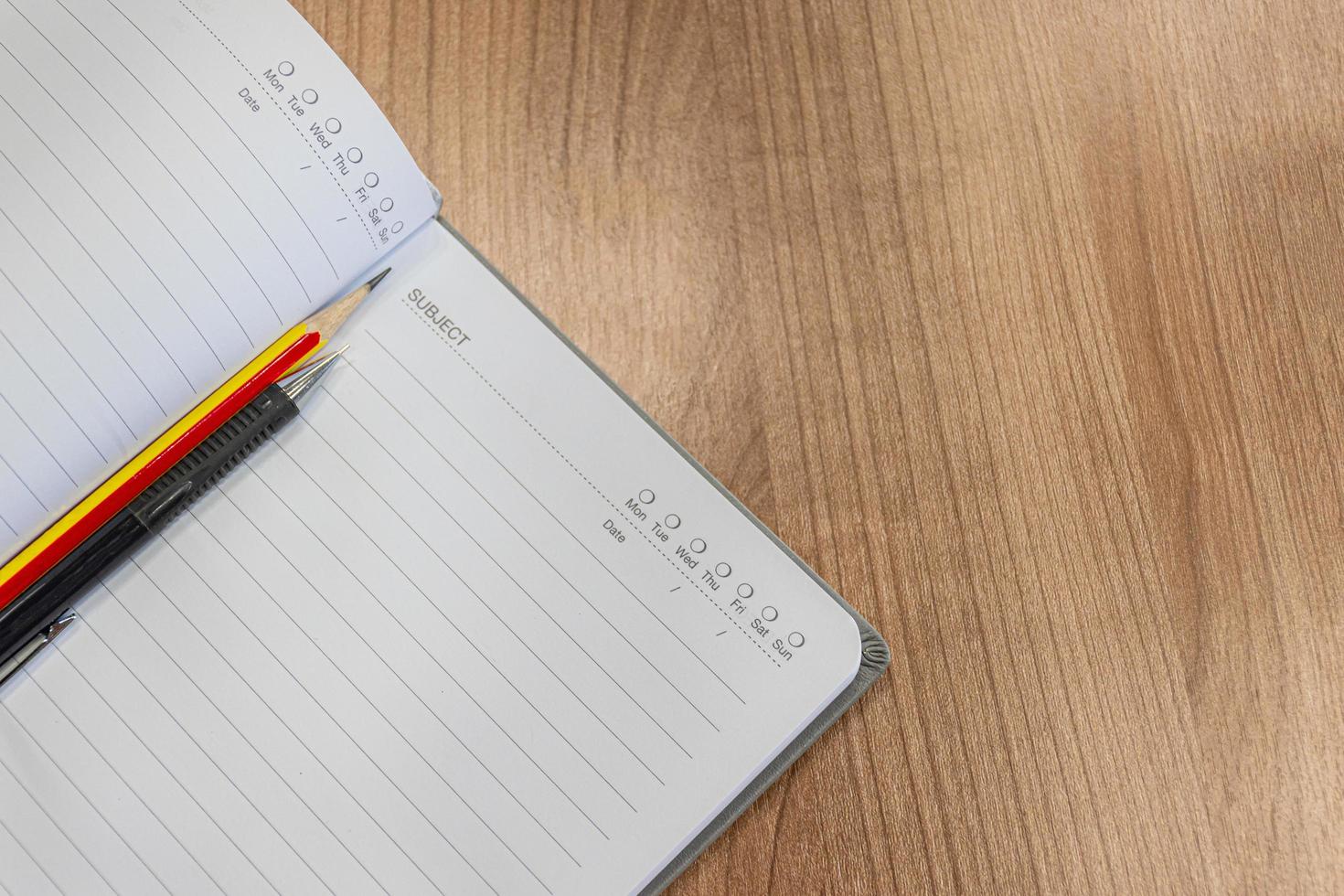 Notebooks with pencil and pen on the table photo