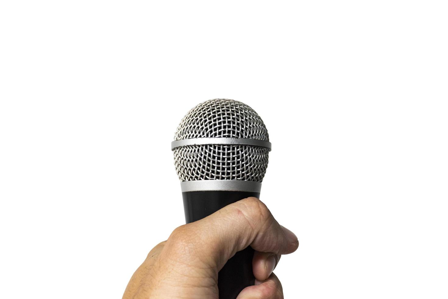 Hand holding a microphone isolated on white background photo