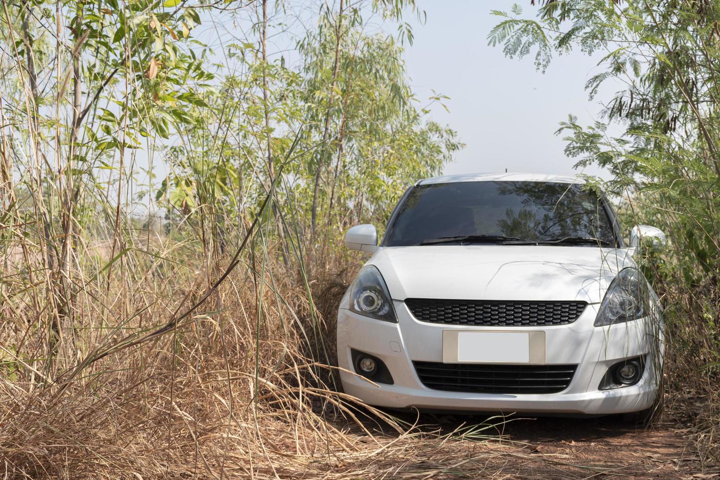 White car on dirt road photo