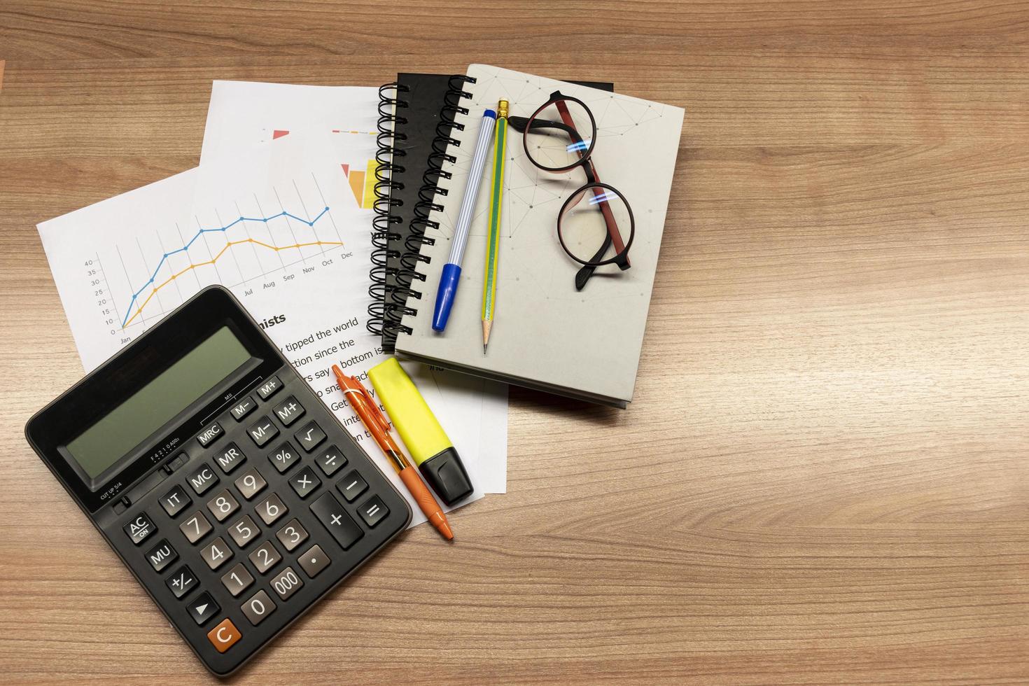 Top view calculator and paperwork on table photo