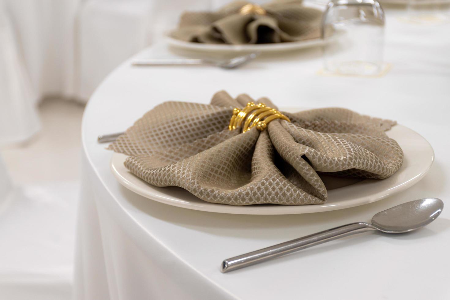 Stainless steel spoon and fork with plate on the table photo