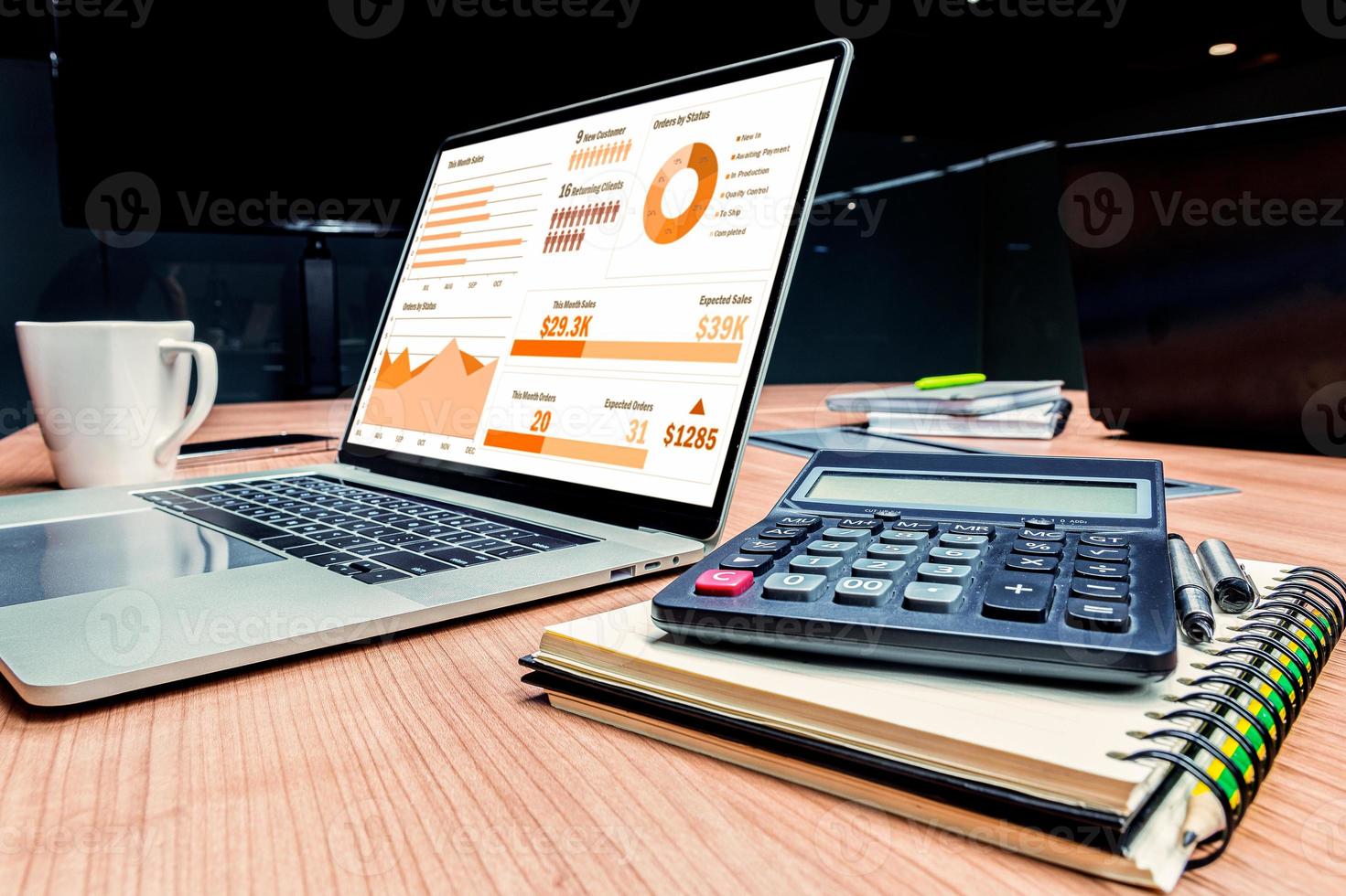 Slide show presentation on display laptop with calculator and notebook on table photo