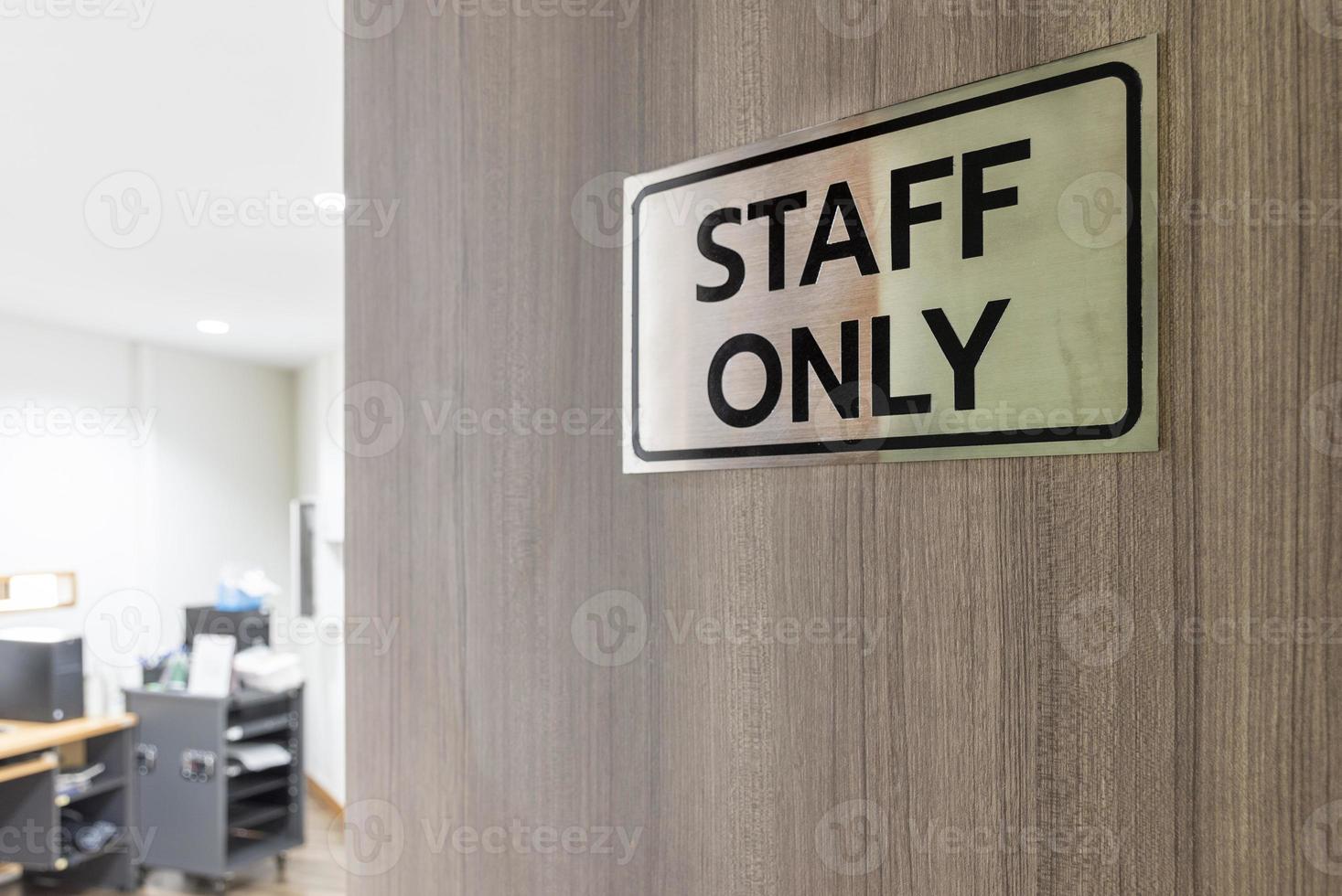 Warning sign in front of the door with a message for staff only with inside the sound control room. photo