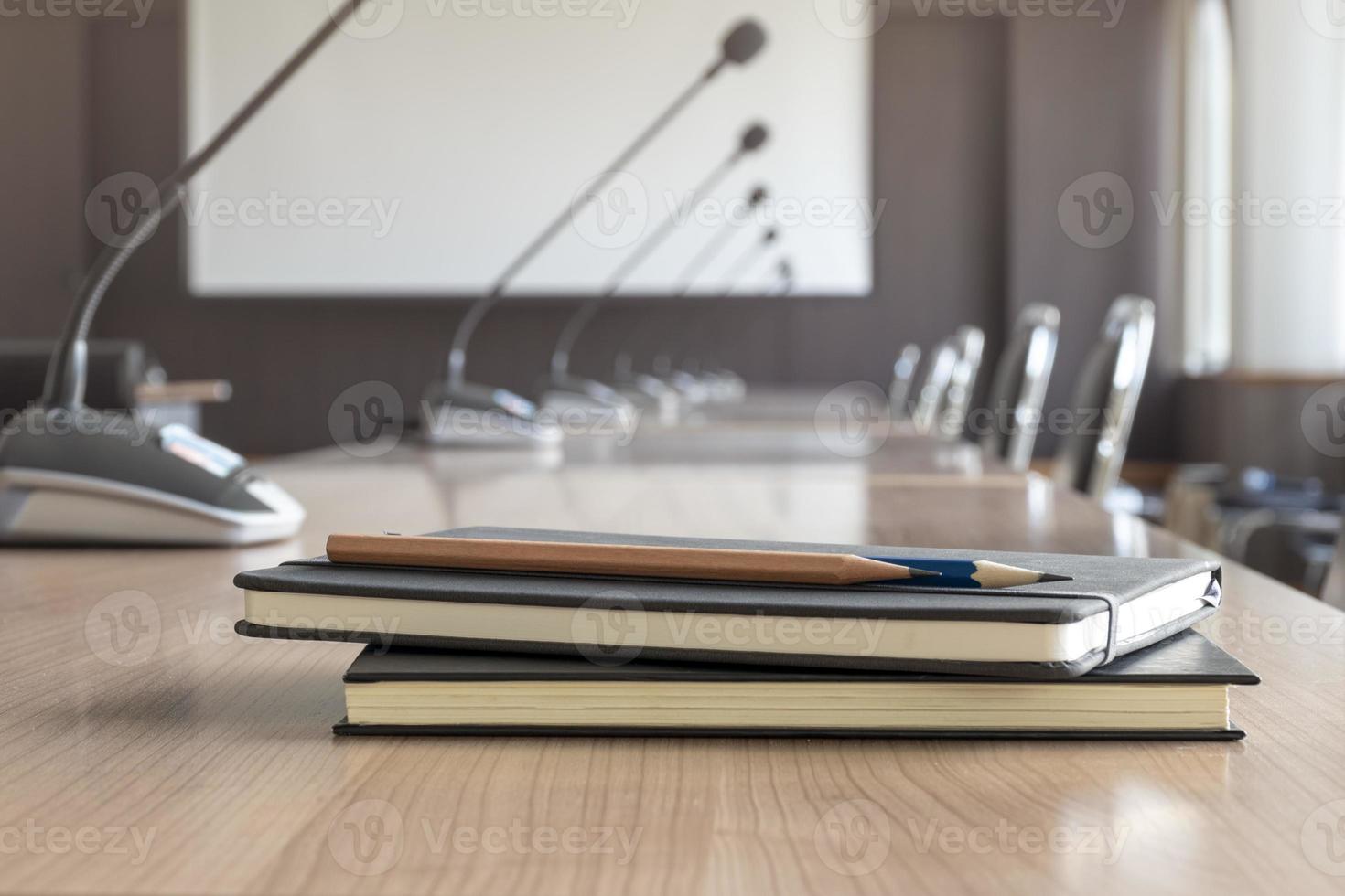 Close up pencil and notebook on table in meeting room photo