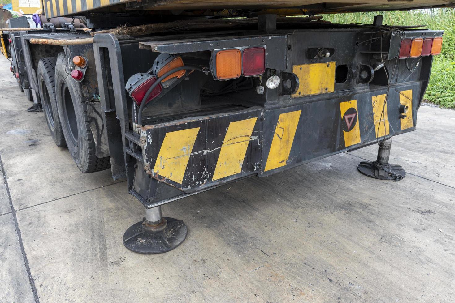Outrigger mobile crane for heavy duty construction side. Hydraulic supports for the crane legs. photo
