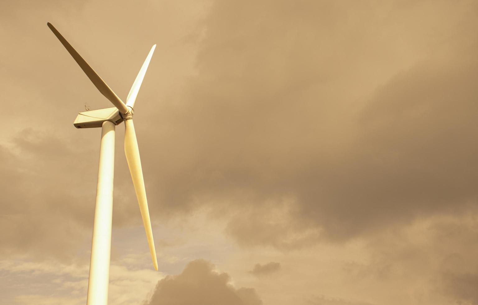 Wind turbines on yellow sky photo