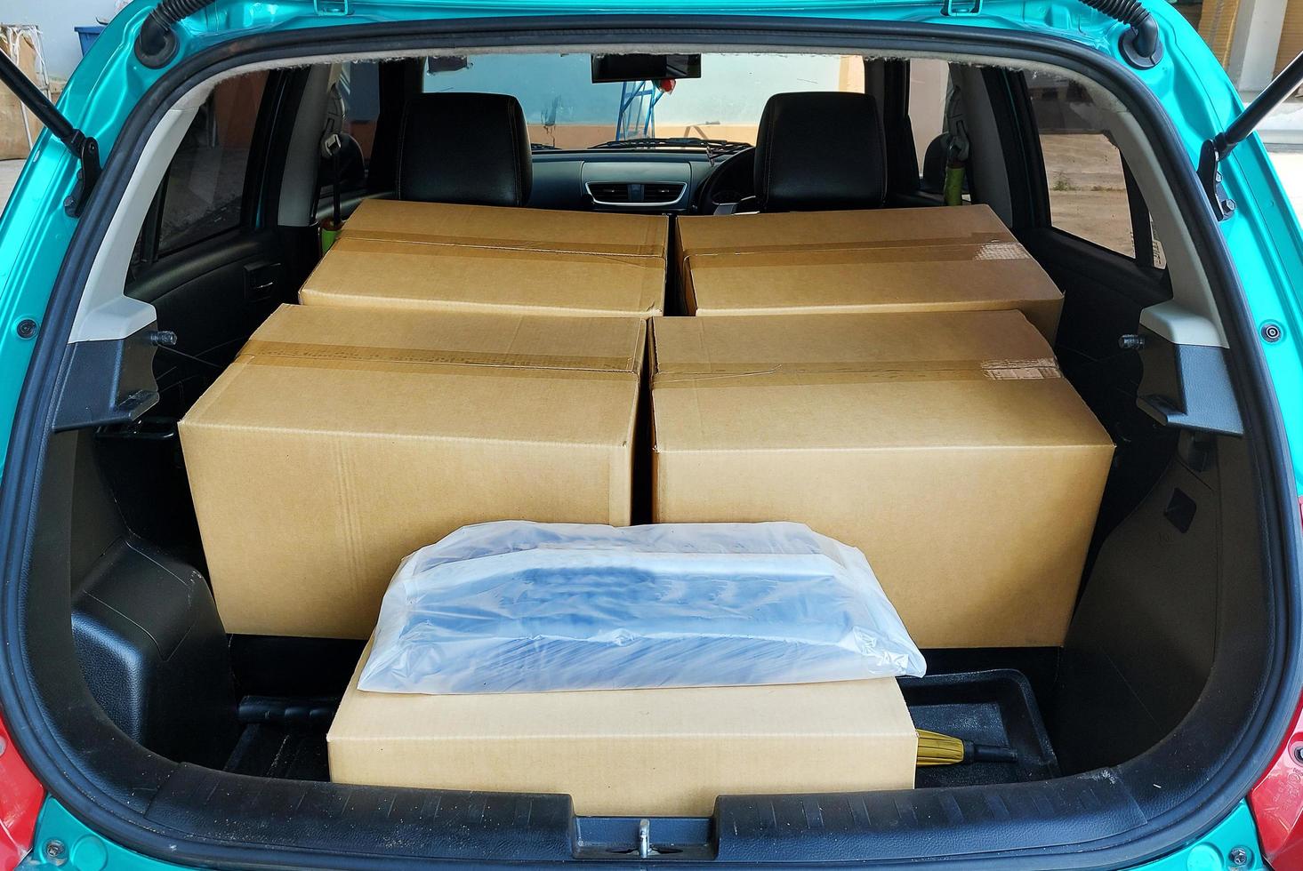 Open back door hatchback view many parcel boxes in car photo