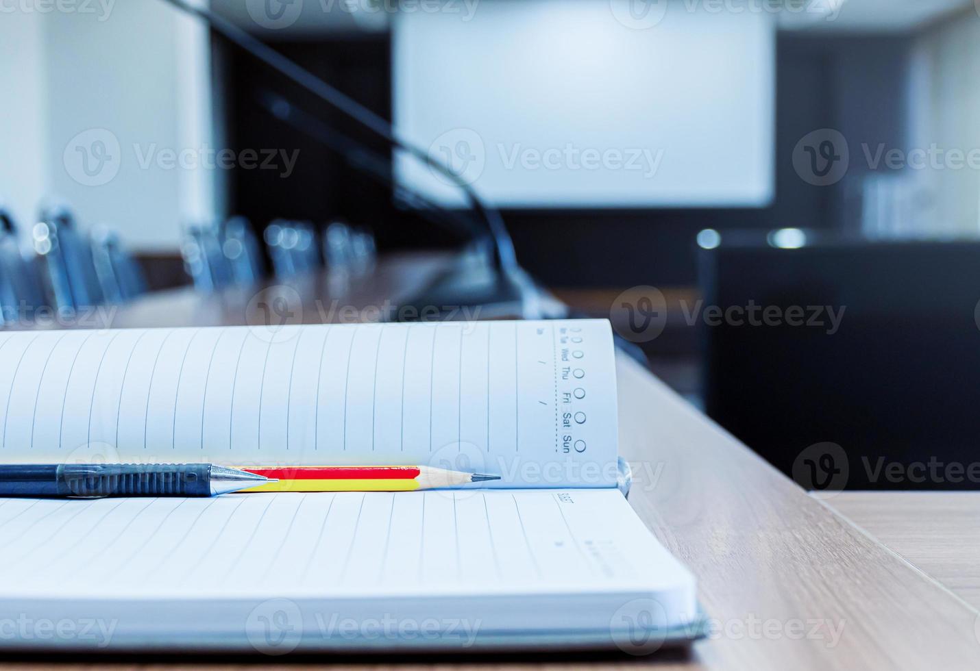 Notebooks with pencil and pen on the table in the meeting room photo