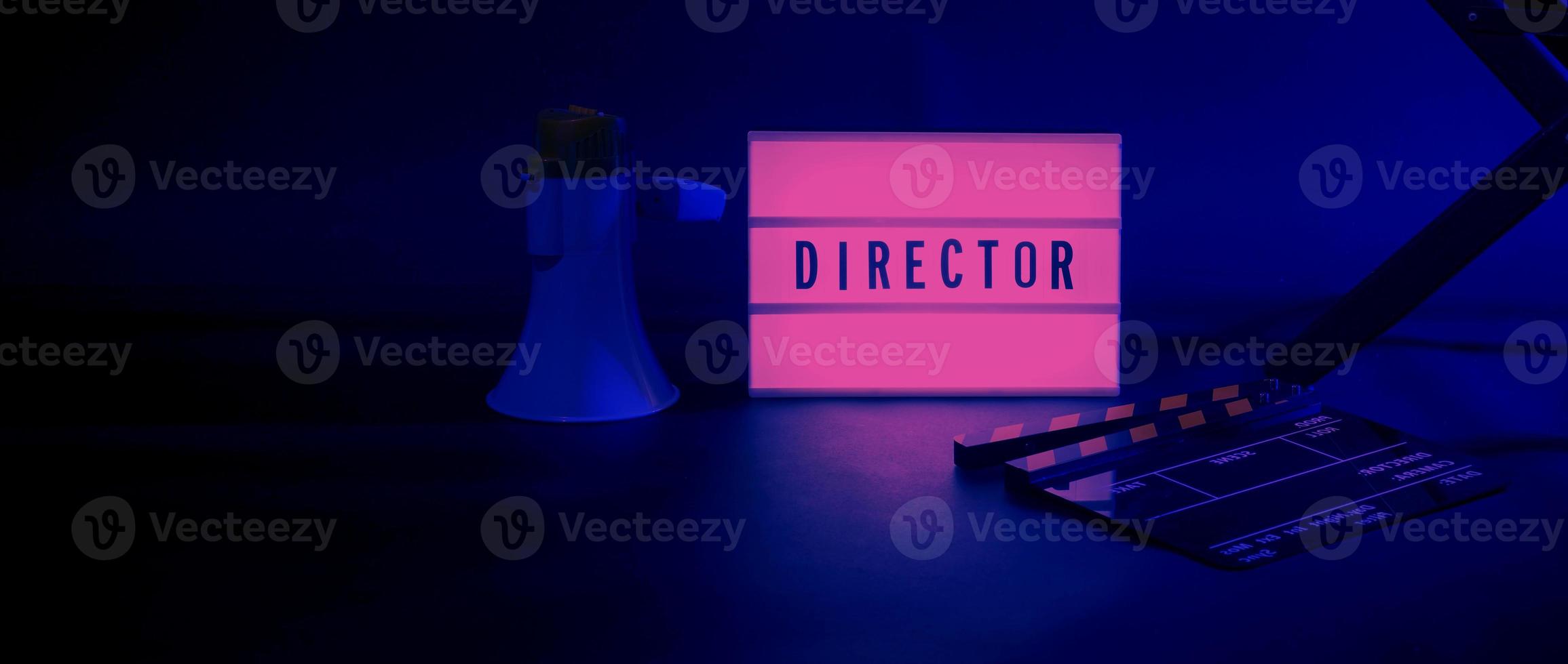 Director chair with cinema lightbox sign Director text on it and clapperboard megaphone photo