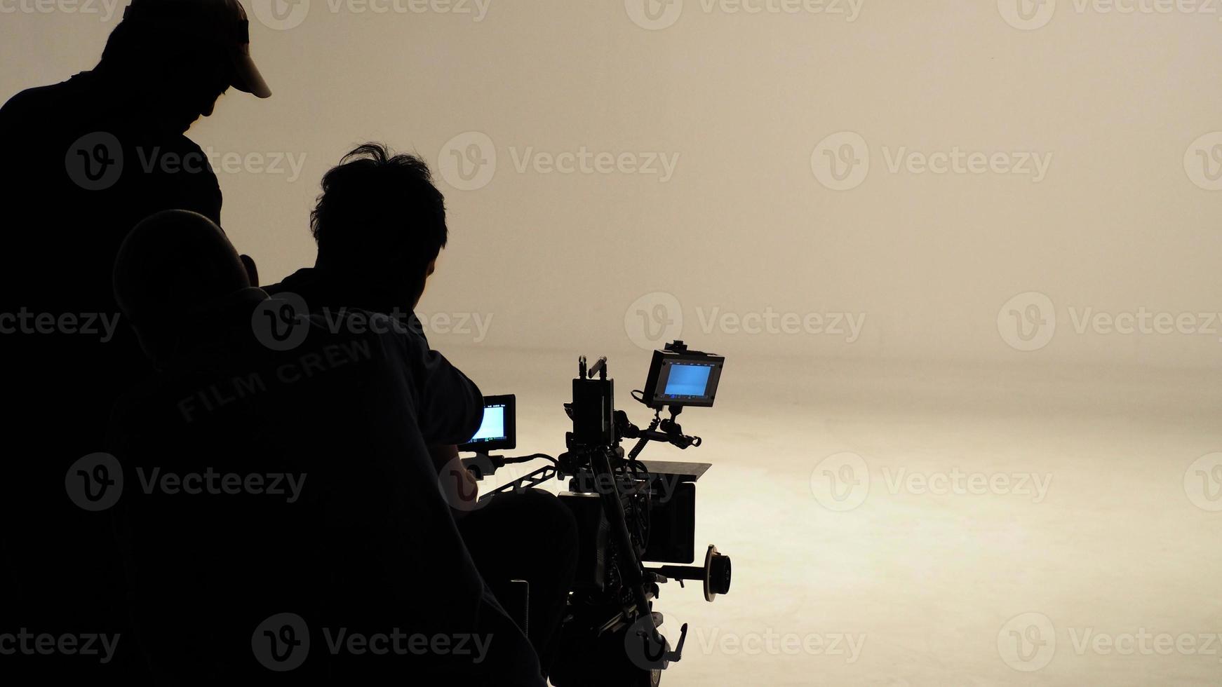 Silhouette of working people or production film crew are making movie or shooting. photo