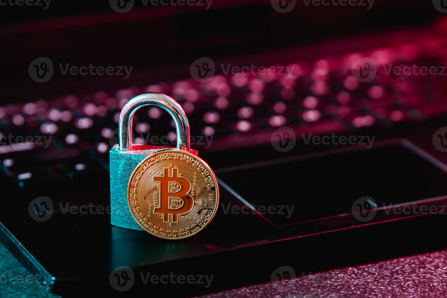 Bitcoin and padlock on laptop photo