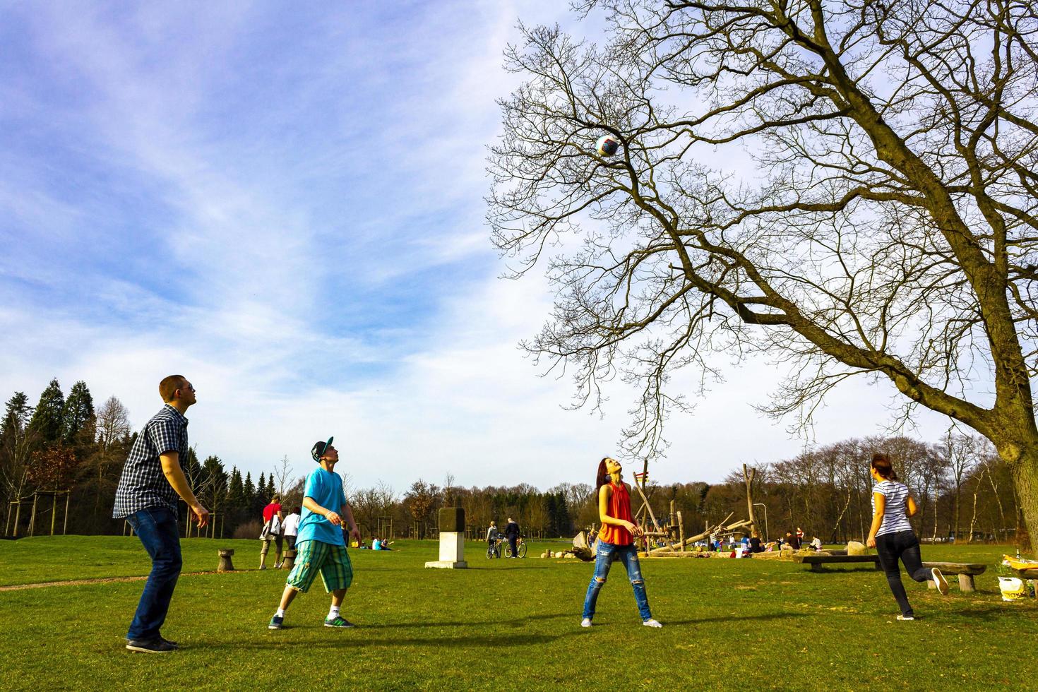 Bremerhaven Bremen Germany 2011 Teenagers play volleyball in park on grass in Germany. photo