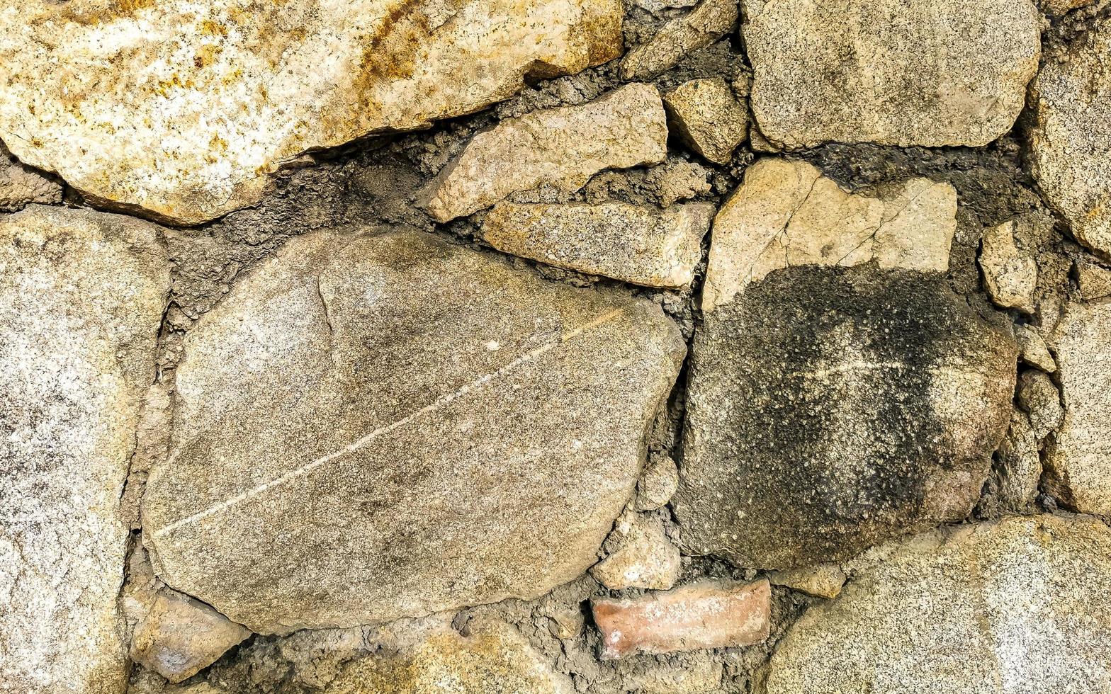Rough stone and brick wall texture pattern Puerto Escondido Mexico. photo
