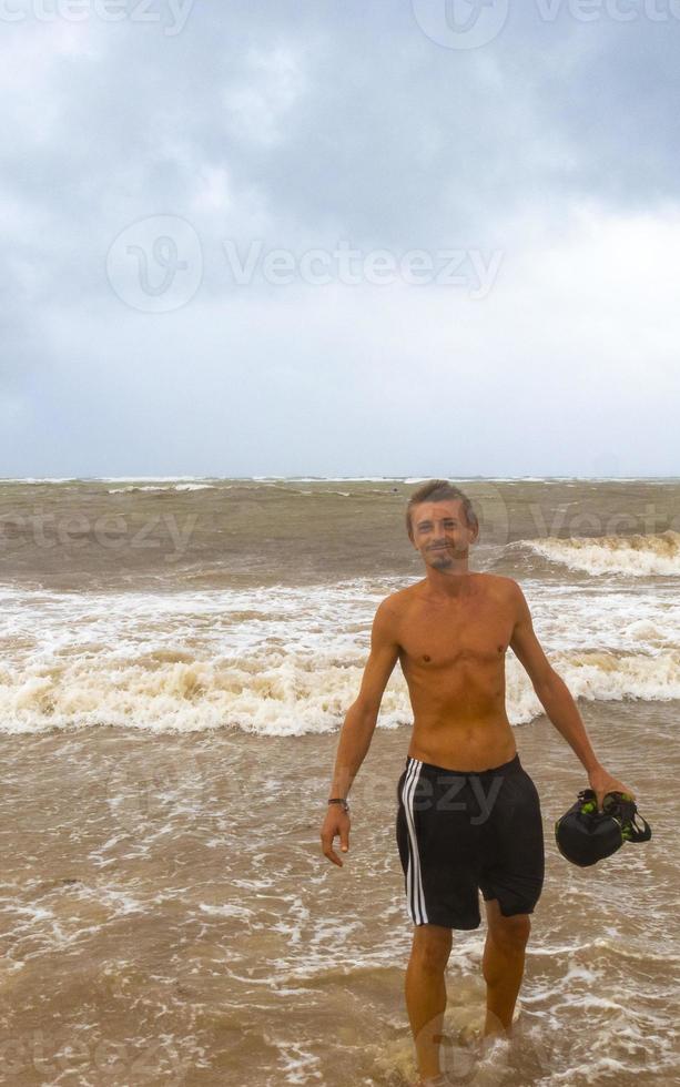 Man is out on beach during hurricane and enjoys Mexico. photo