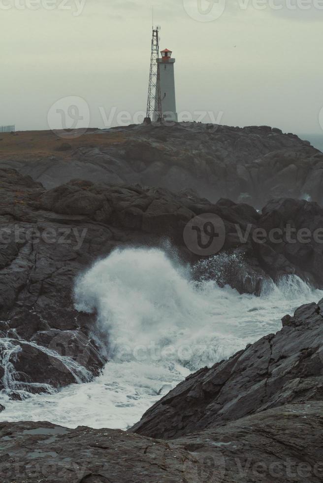 Stokksnes lighthouse on cliff at storm landscape photo