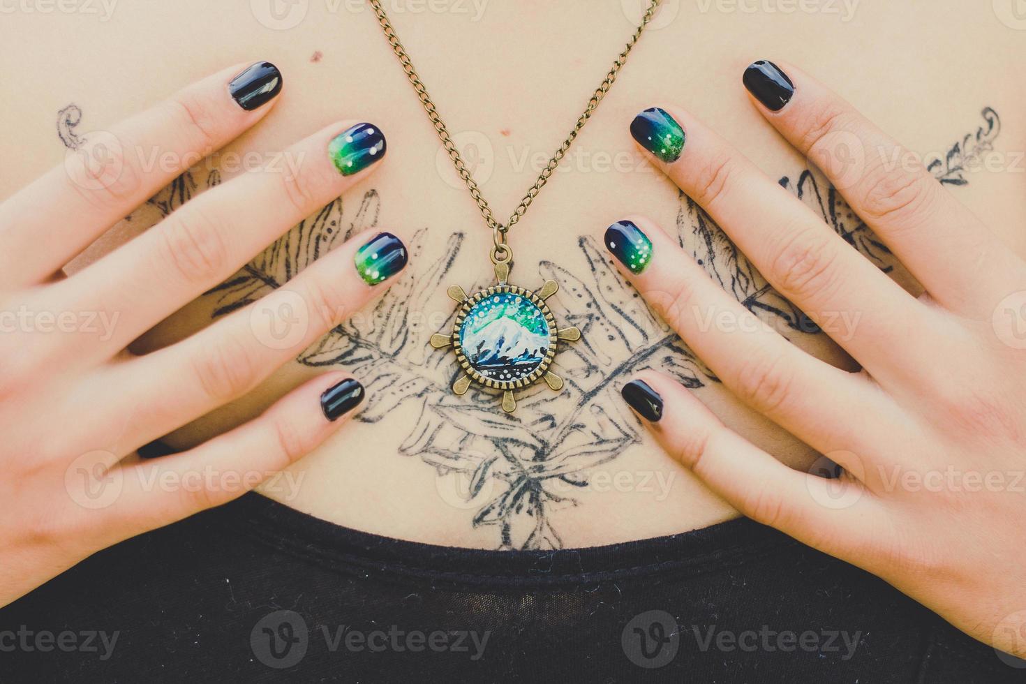 Close up woman with craft pendant and manicure concept photo