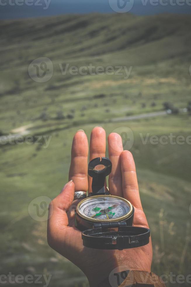 Close up woman holding compass concept photo