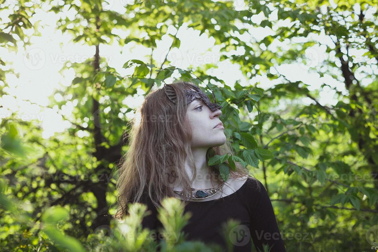 Woman wearing fantastic druid bird mask scenic photography photo