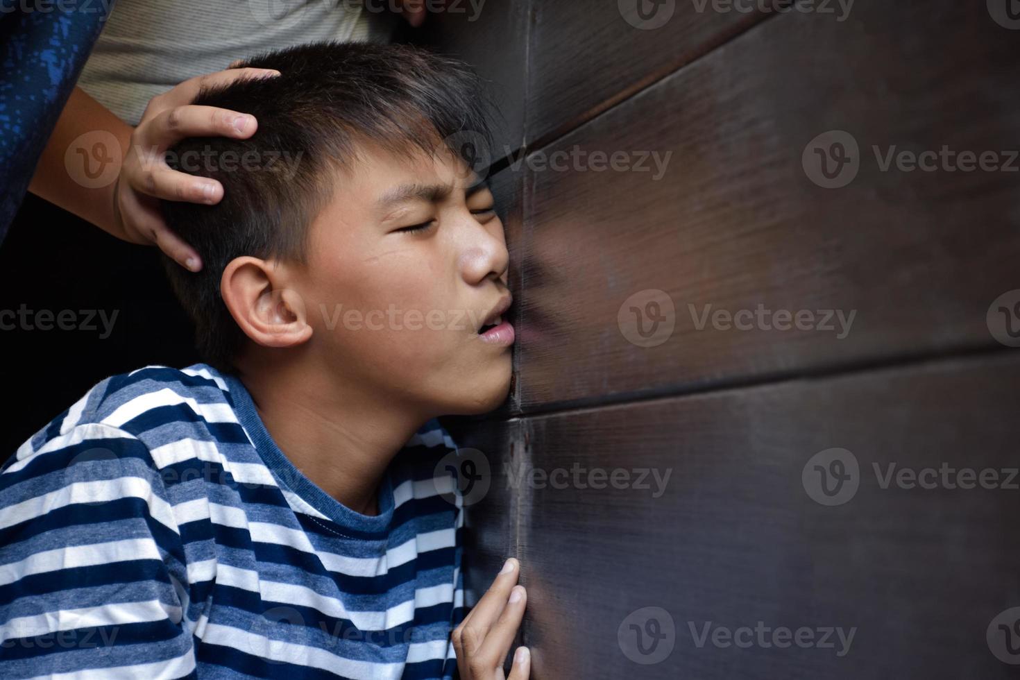 Asian secondary school boy was intimidated by bad habit students at the wall of the bathroom, soft and selecitve focus, bad habit students and teenagers concept. photo