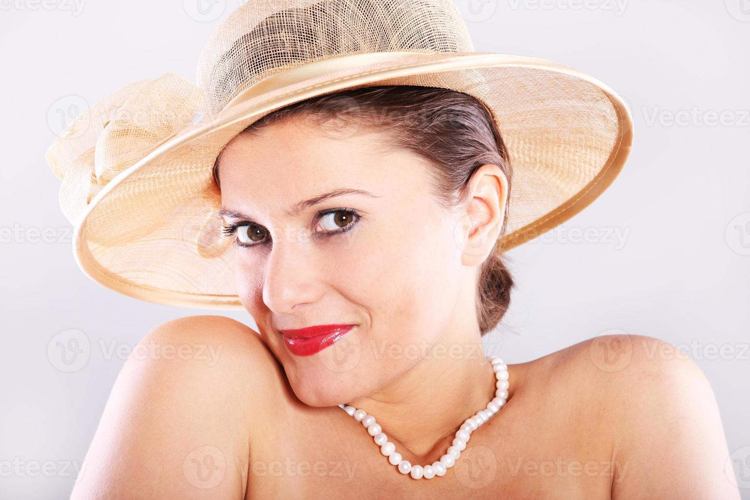 Shy woman with hat photo