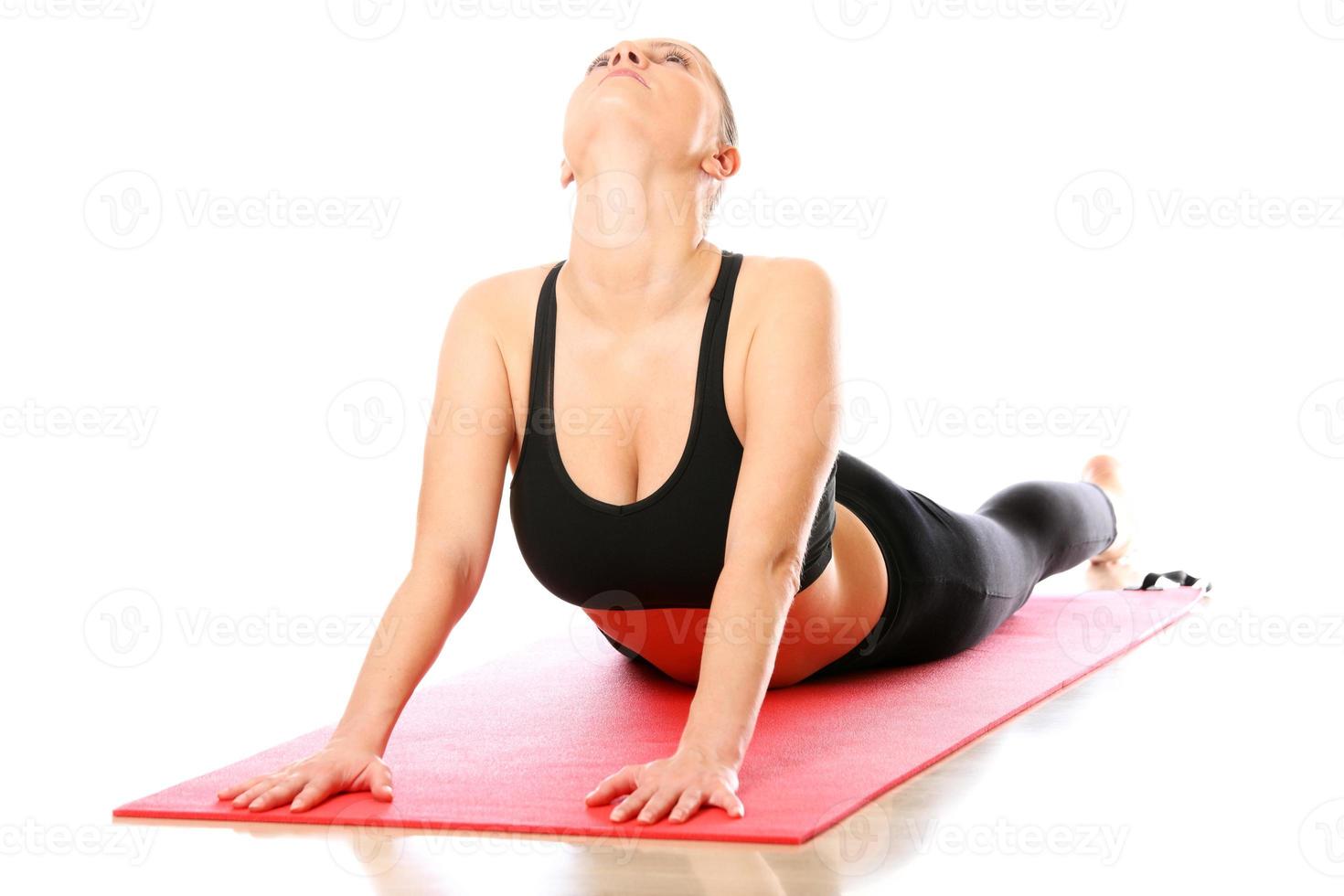 Woman stretching on a yoga mat photo