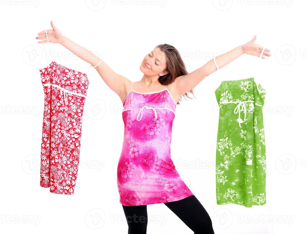 Woman choosing between dresses photo