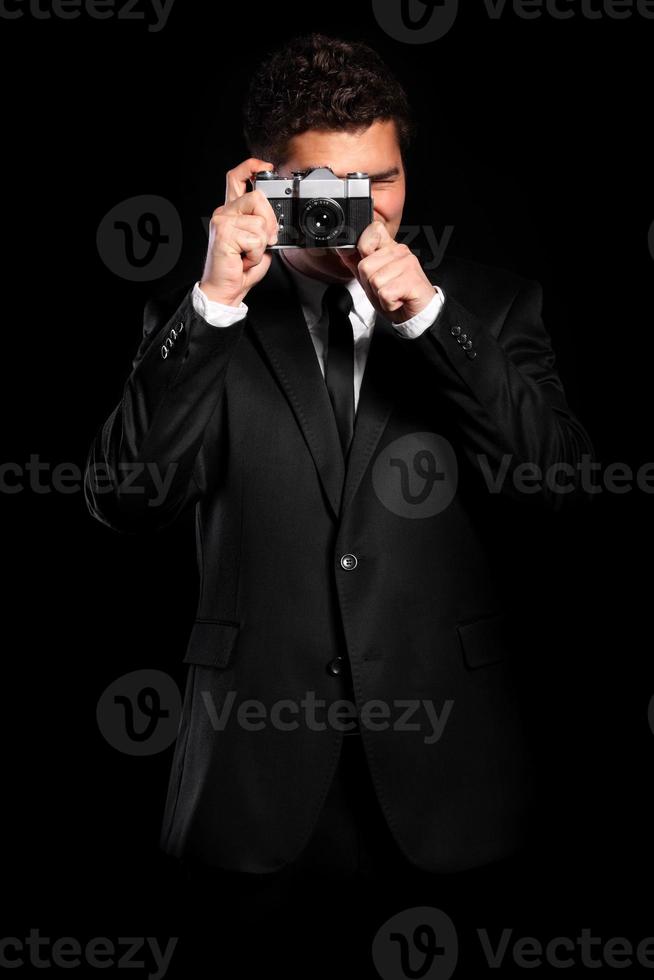 Elegant photographer on black background photo