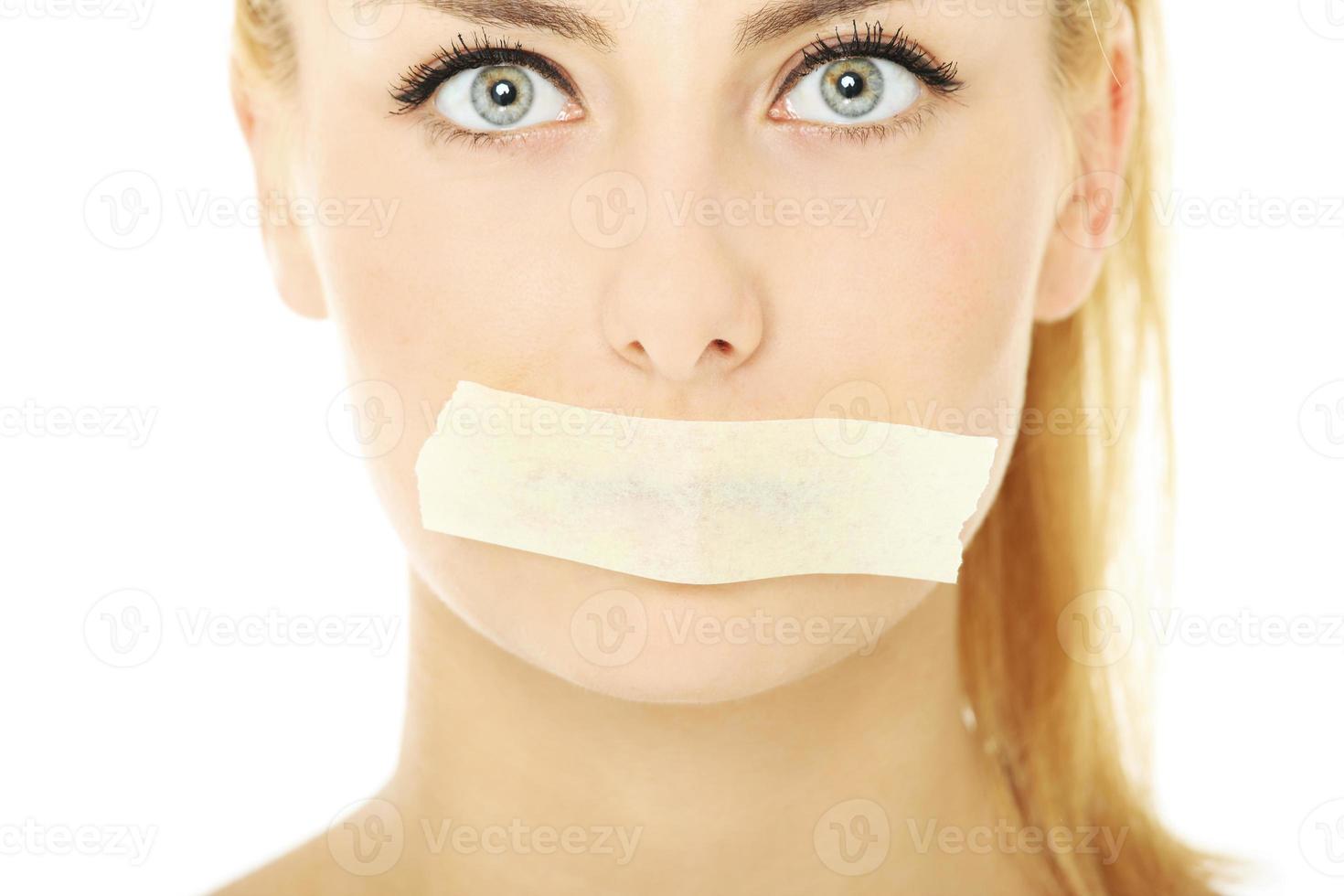 Woman with tape on the mouth photo
