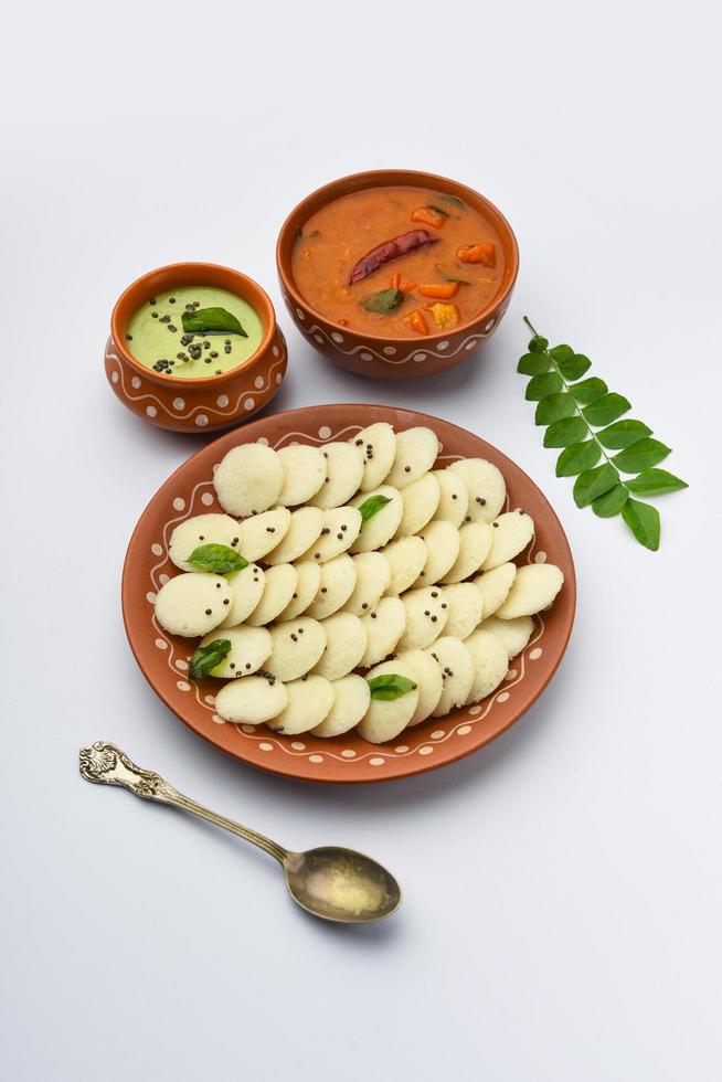 Mini idli is the smaller version of soft and spongy round shaped steamed regular rice idli, also known as button and cocktail idly photo