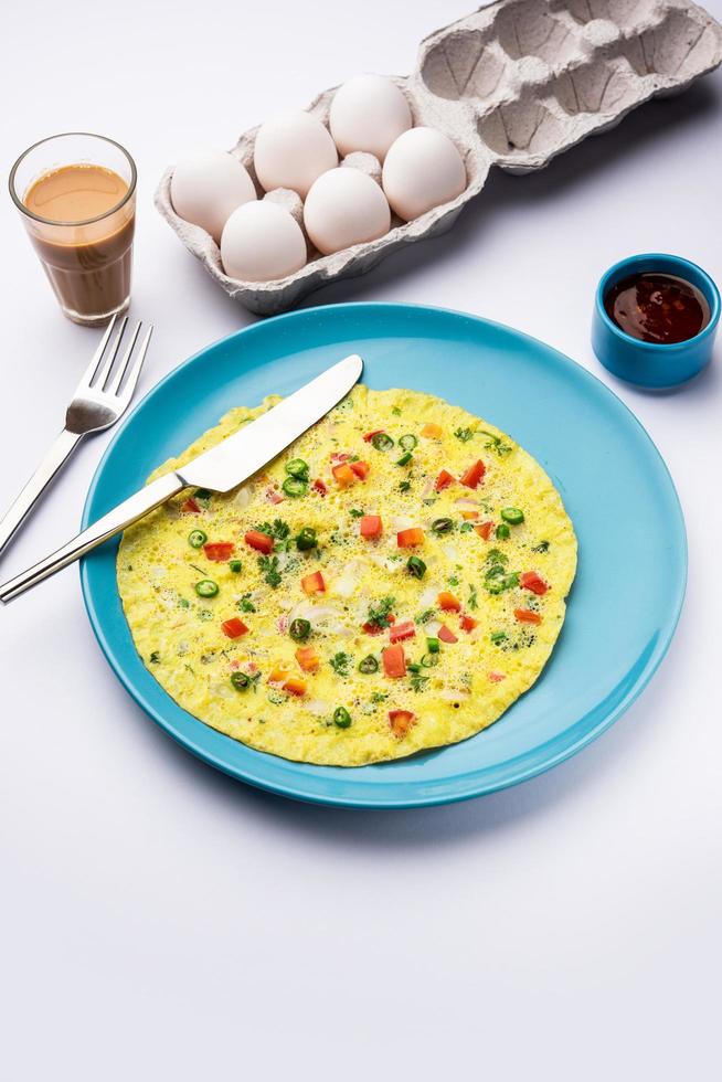 Indian Spiced Masala Omelet filled with fresh vegetable, healthy meal photo