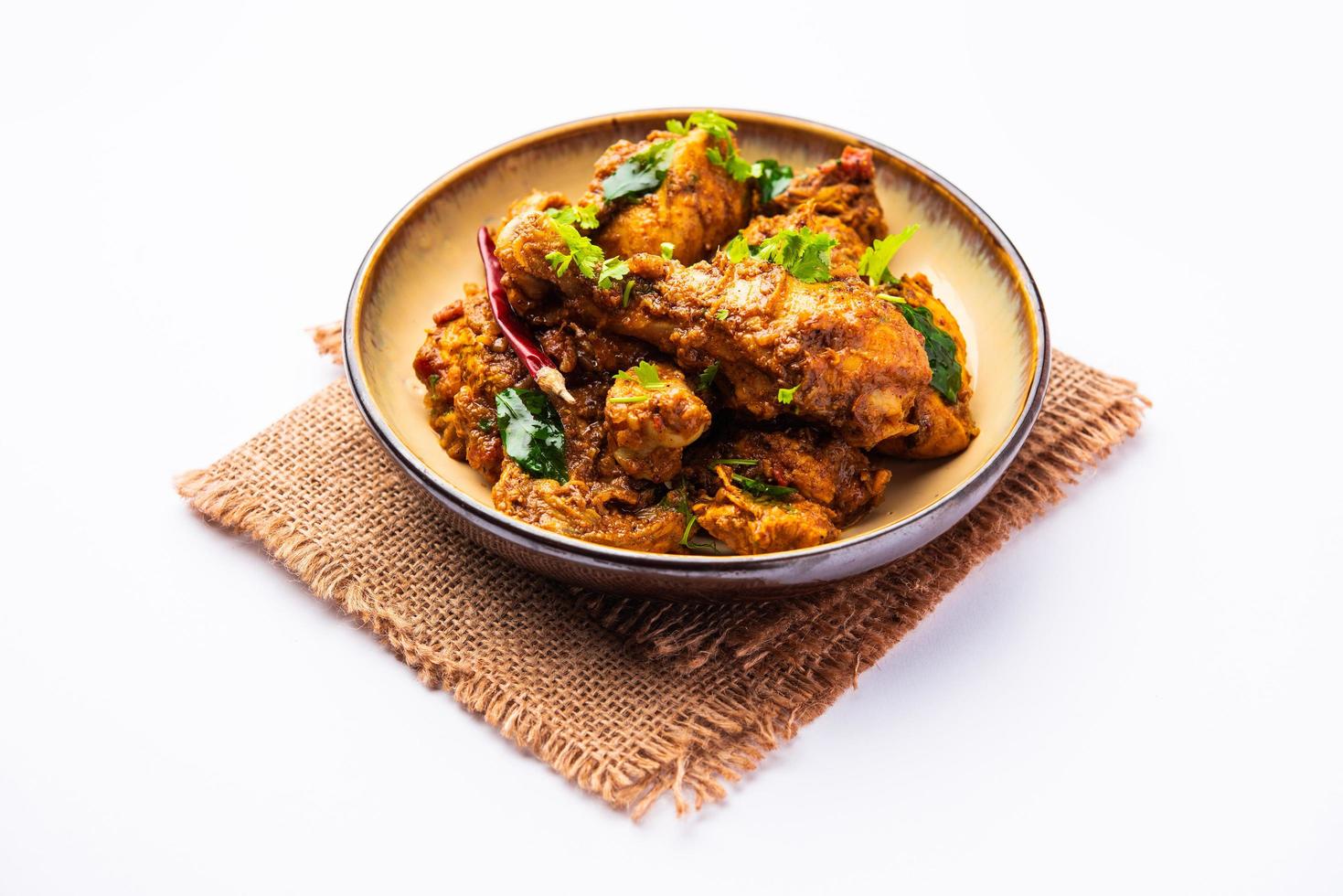 Sukha mutton or chicken, dry spicy Murgh or goat meat served in a plate or bowl photo