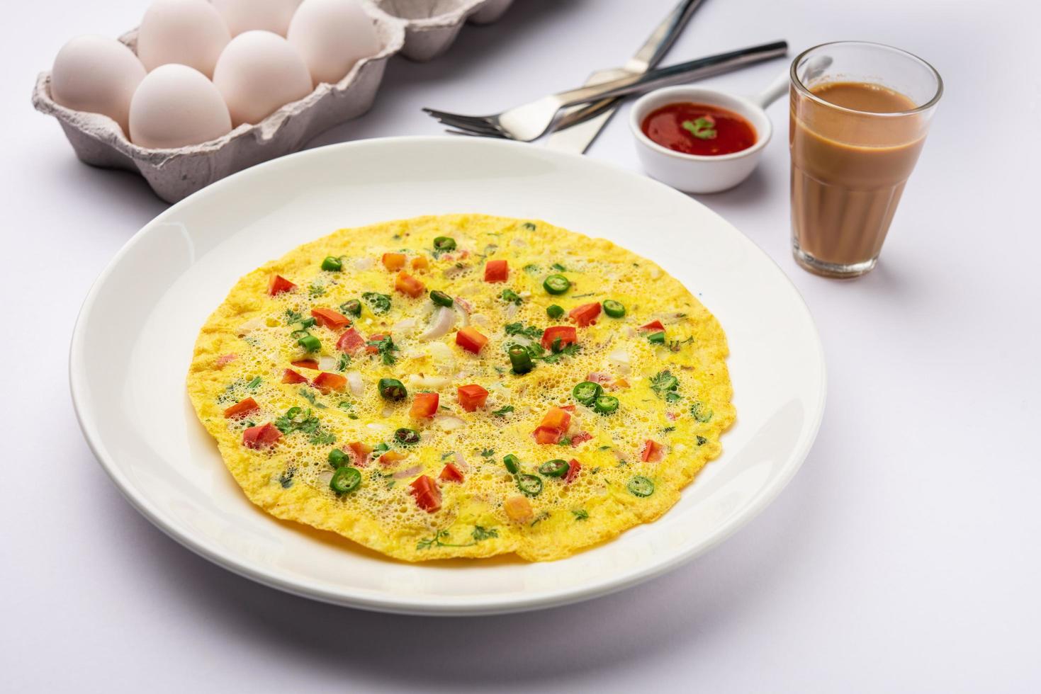 Indian Spiced Masala Omelet filled with fresh vegetable, healthy meal photo