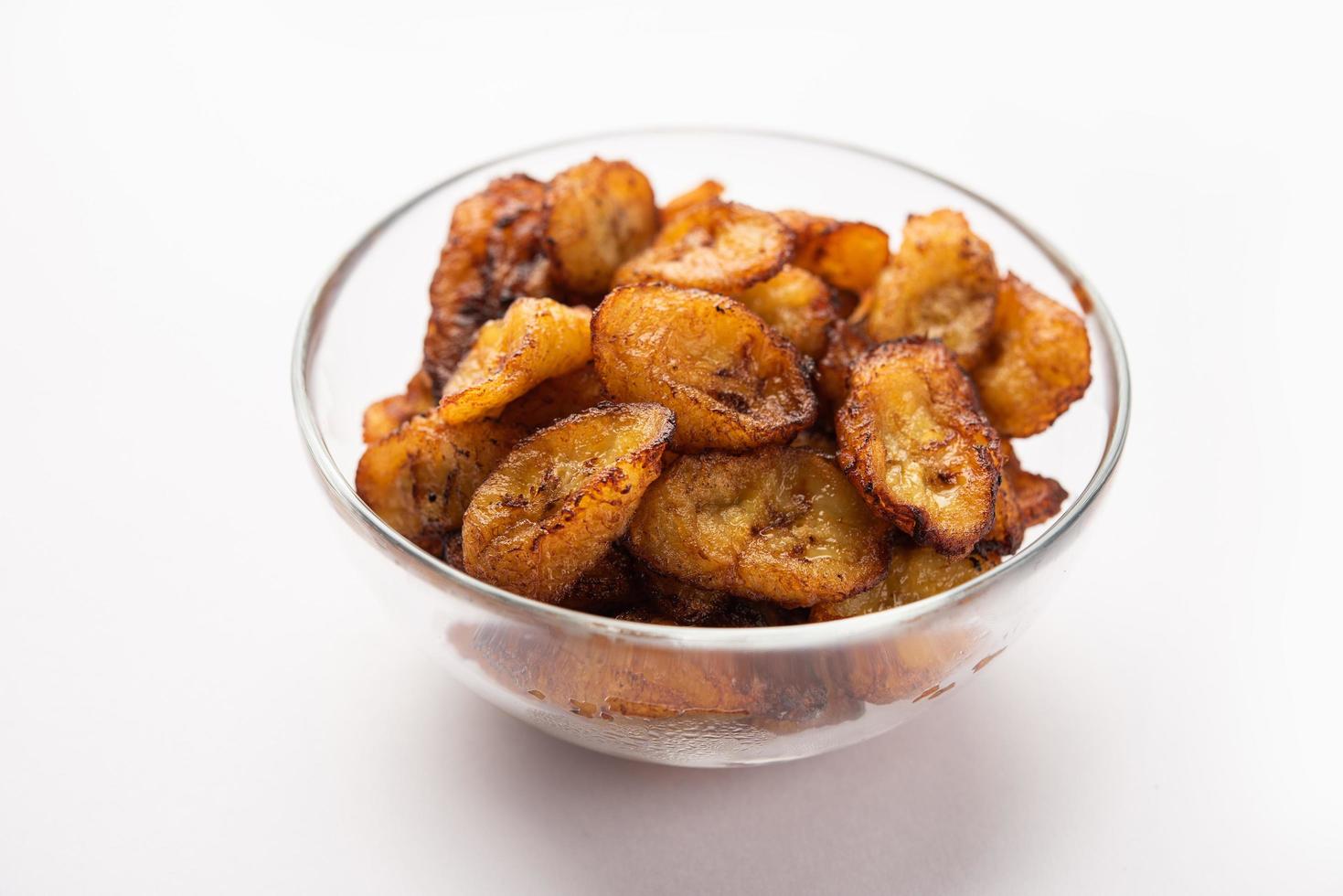 Deep fried ripe plantain slices or pake kele fried chips in a bowl photo