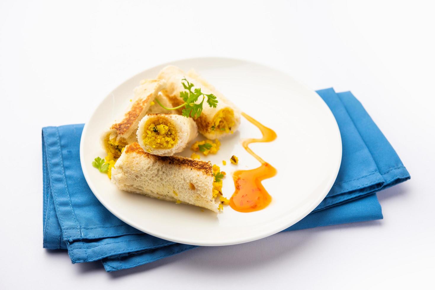 Indian paneer bread roll made using spiced grated cottage cheese mixed with spices, rolled and baked photo