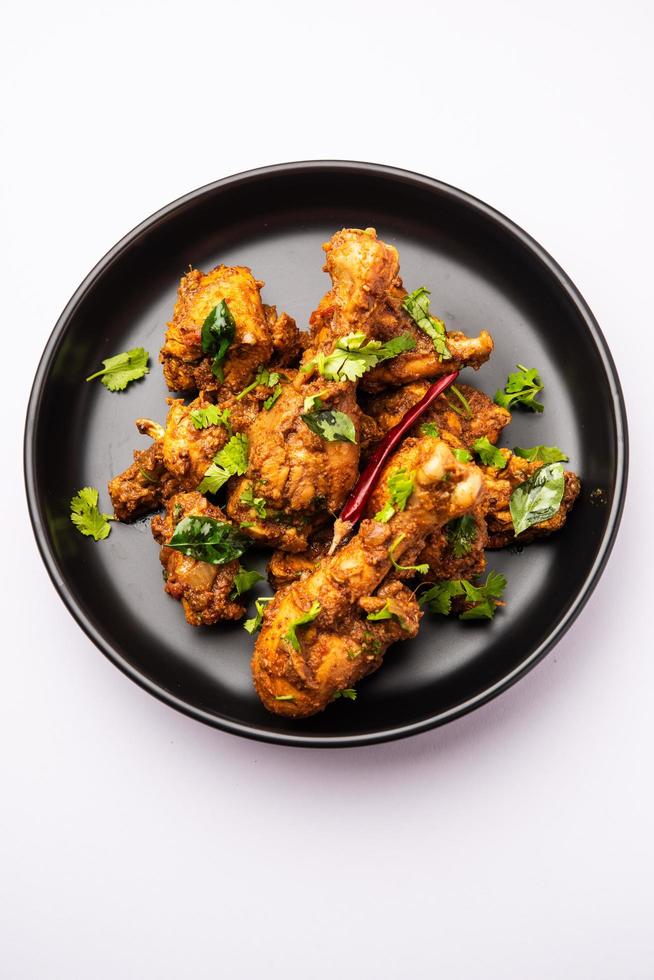Sukha mutton or chicken, dry spicy Murgh or goat meat served in a plate or bowl photo