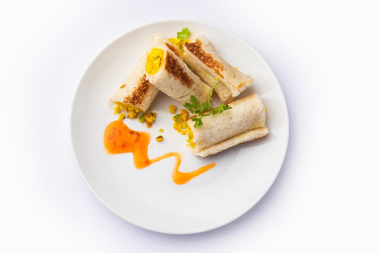 Indian paneer bread roll made using spiced grated cottage cheese mixed with spices, rolled and baked photo
